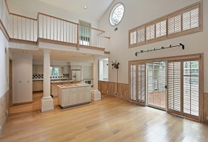 Open concept residential interior design featuring extensive hardwood flooring installation